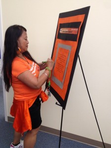 YWCA staff signing Pledge Against Racism at Seneca site and sporting orange in support! 