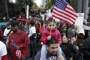 A young May Day protester rides atop her father's shoulders as the march reaches downtown.  Photo credit, Seattle Times. 