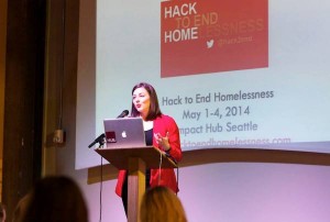 Hack to End Homelessness organizer Candace Faber addressed the crowd before nonprofit representatives pitched projects to tech volunteers. Photo credit: Michael B. Maine.