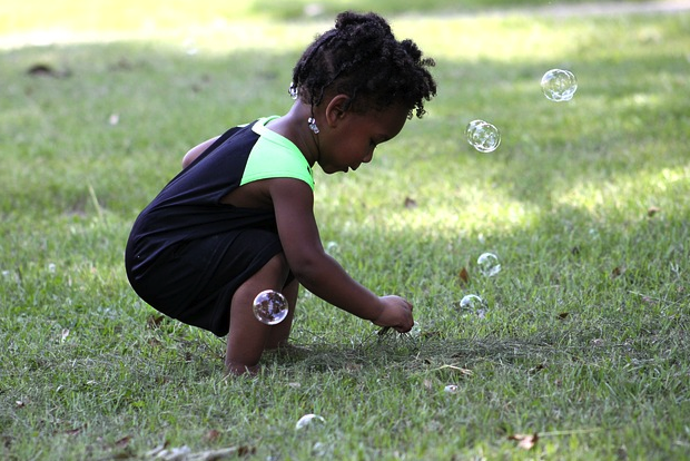 Photo child plays with bubbles