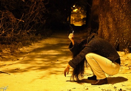 Image of woman crouching outside