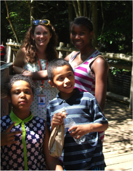 Laurel Kirbawy-Grenfell enjoys a sunny day with a few young residents of YWCA Passage Point. As a Children's Advocate, Laurel works to ensure that students in her program, including many kids who have experienced homelessness, have the resources they need to succeed in school. Image credit: Laurel Kirbawy-Grenfell 