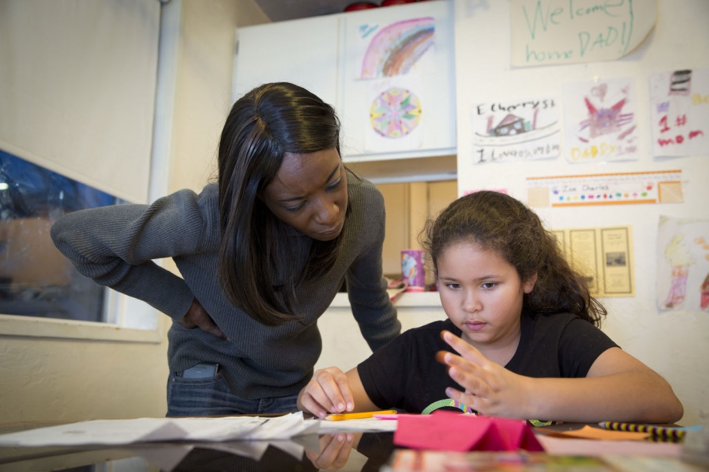 After school, Zoe reads and works on homework with her mom's help.