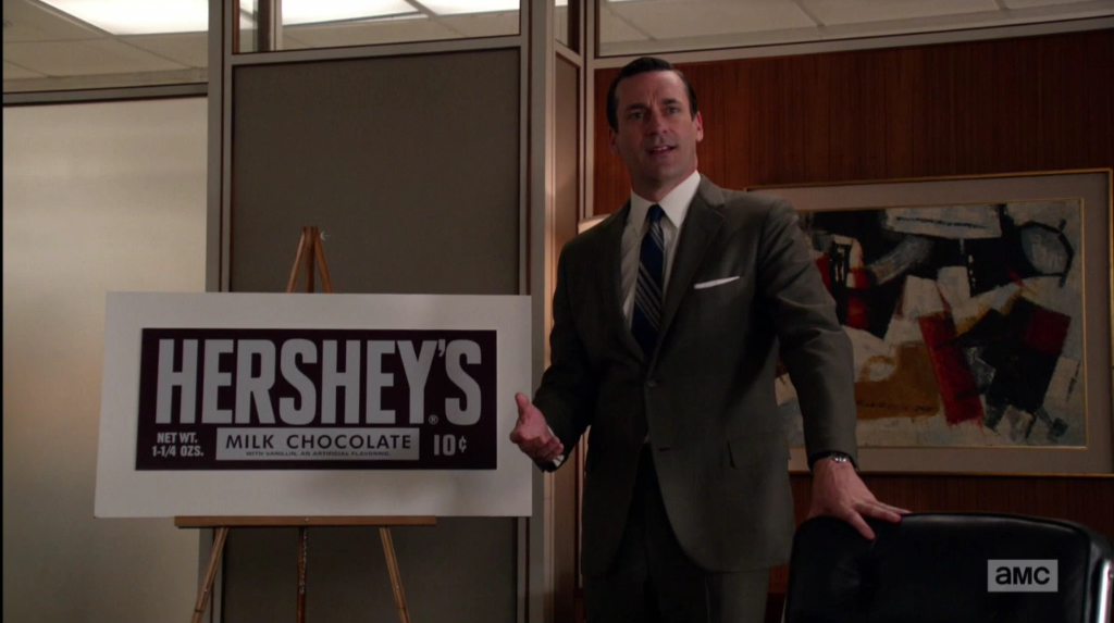 Don Draper giving his most famous new business pitch, just before revealing a shocking secret from his past about a Hershey bar. Photo from AMC.