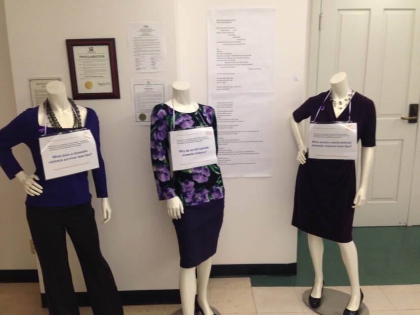 In the lobby of the downtown Seattle YWCA building, purple-clad mannequins invite passersby to read a community poem about domestic violence.